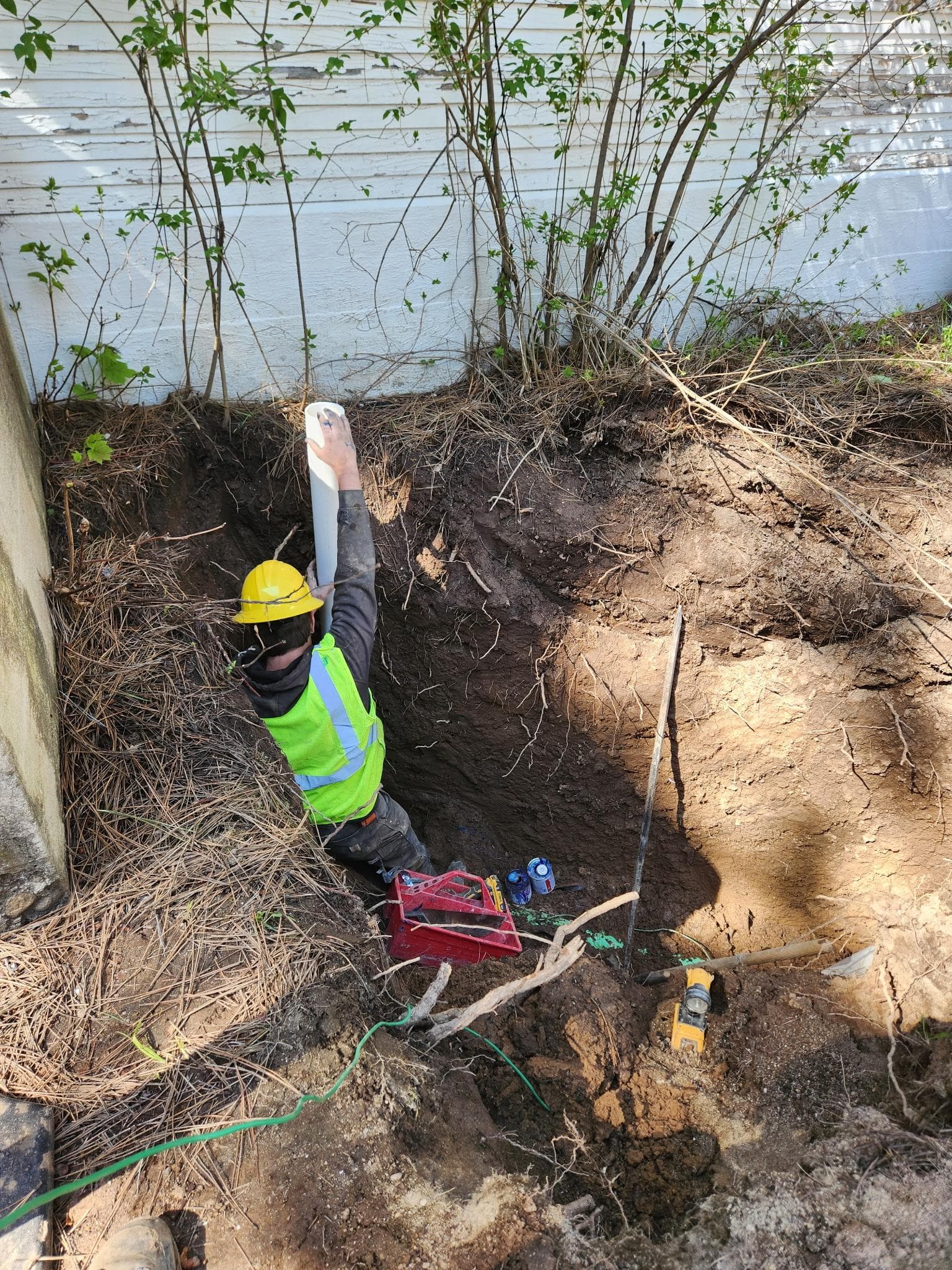 Worker in trench during drainfield installation.